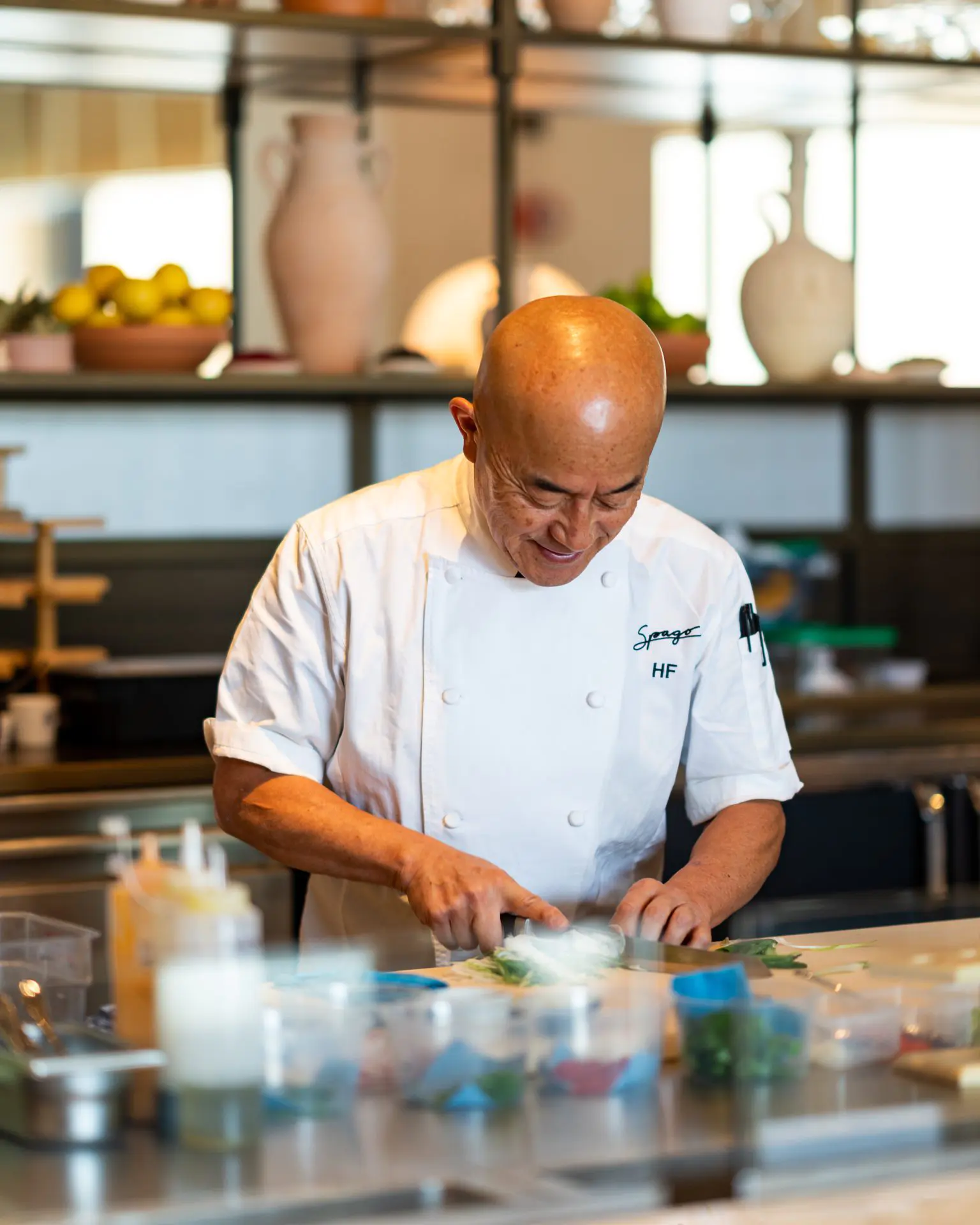 A chef is preparing food in the kitchen at Spago restaurant in Riyadh - Cool Inc