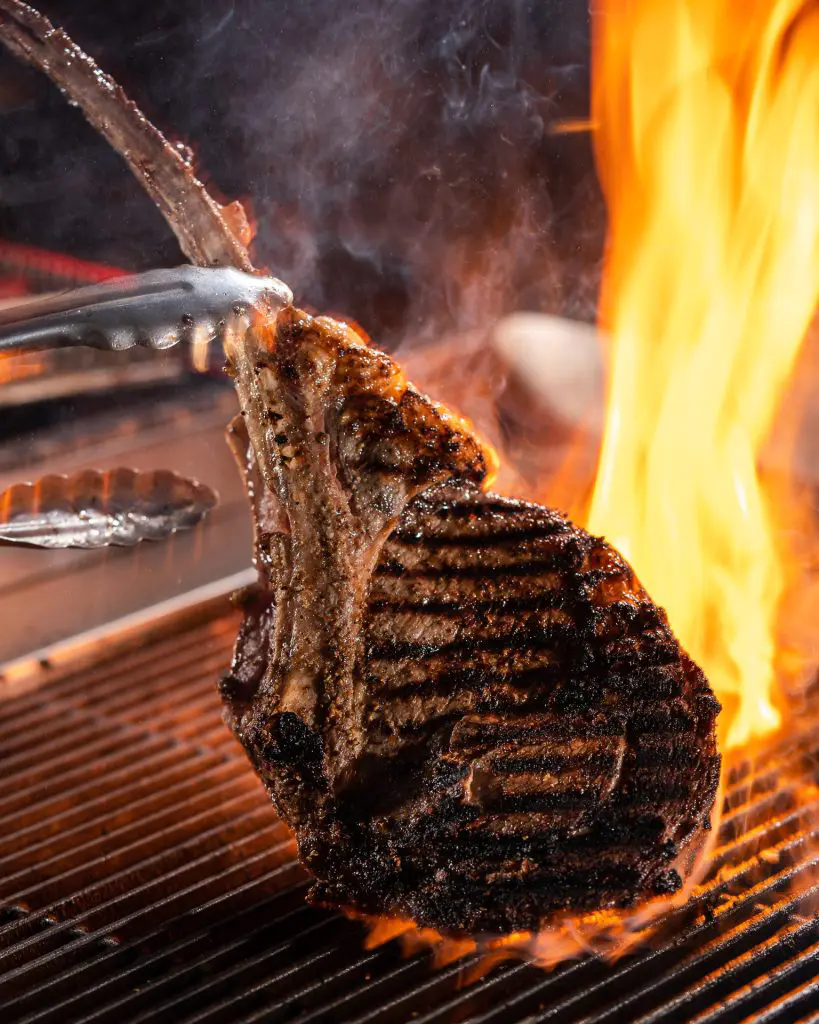 Delicious Tomahawk Pork Chop Being Prepared at CHI SPACCA, an Italian Steakhouse Dining Restaurant in Riyadh - Cool Inc